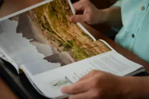 Reader holding an arts and science magazine